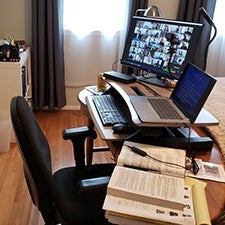 A desk with a computer monitor and laptop
