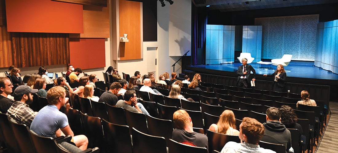 Hiroshi Motomura (left) and Ur Jaddou speaking to a student audience in a theater