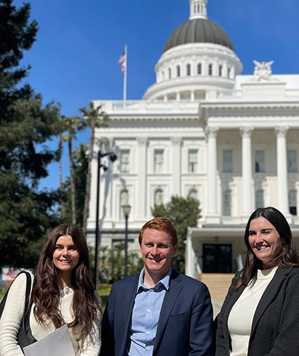 From left: Adrianne Davies, Owen McAleer, and Gabi Rosenfeld outside the California State Capitol. (Photo by Julia Stein)