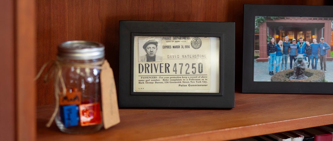 Items on a shelf with the focus on a taxi driver's license for David Waterstone