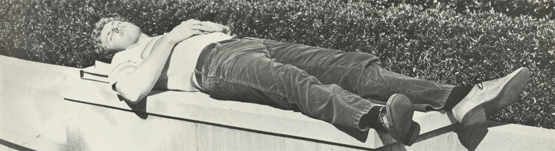 UCLA Law student laying on a bench