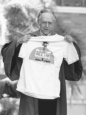 Harry Blackmun holding a UCLA Law t-shirt