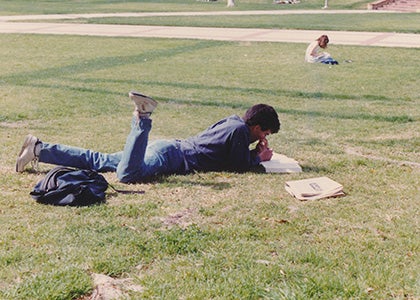 UCLA Law student laying on grass in Dickson Court