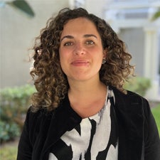 Headshot photo of Antonia Moure Richard in front of green landscape
