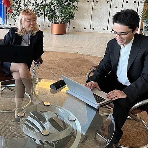 UCLA Law students seated at a table with a laptop