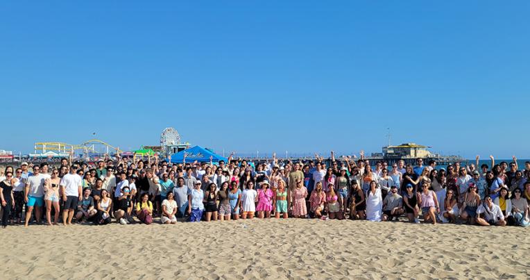 Group photo of LLM students on the beach