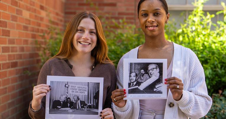Left to right: Kitty Young and Evan Mitchell Zepeda hold photos of their relatives, civil rights icons Joseph L. Rauh Jr. and Clarence M. Mitchell Jr.