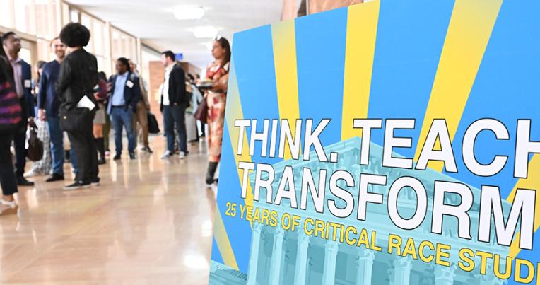 Poster for the CRS symposium with attendees in the background