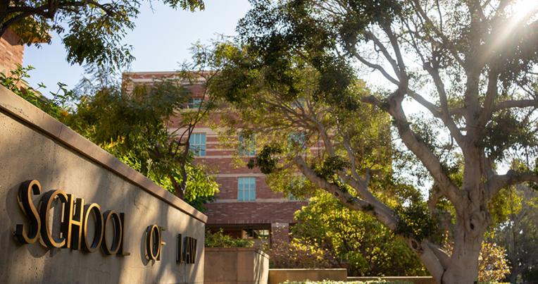 UCLA School of Law entrance sign with tree in foreground. Photo by Sabrina Chang
