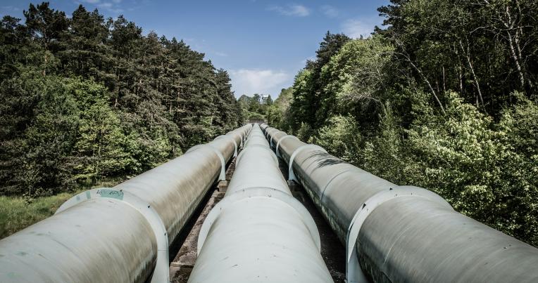 A series of industrial gas pipelines heading into the horizon