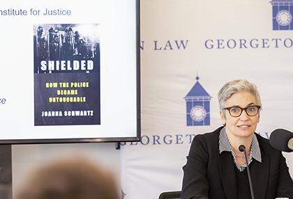Joanna Schwartz with the cover of her book Shielded: How the Police Became Untouchable