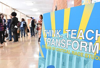 Poster for the CRS symposium with attendees in the background