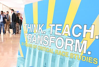 Poster for the CRS symposium with attendees in the background