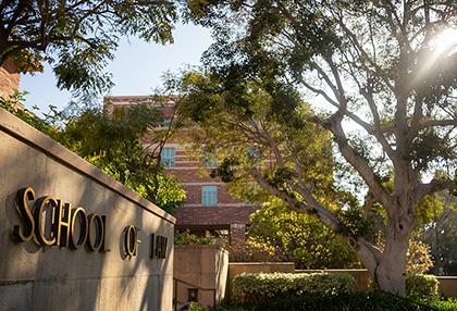 UCLA School of Law entrance sign with tree in foreground. Photo by Sabrina Chang
