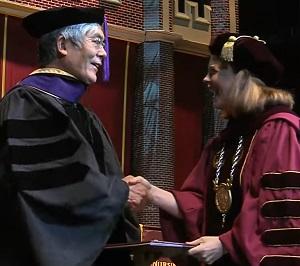 UCLA Law professor Hiroshi Motomura accepts an honorary degree from Loyola University New Orleans president Tania Tetlow on May 11.
