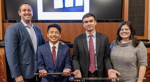 Justin Bernstein; Jonathan Kuang of UCLA, wielding the pipe exhibit from the case; University of Cincinnati student Stephen Johnson, holding the engraved sword he received; and Drexel assistant director of trial advocacy Abbie Heller.